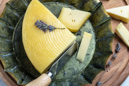 Piece of lavender cheese with dry lavender flowers, Ecology and eco-products. Restaurant menu, dieting, cookbook recipe.の写真素材