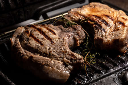 Grilled pork steaks on the grill. Restaurant menu, dieting, cookbook recipe.の写真素材
