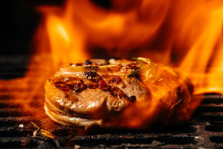 Grilled bbq steak with fire flames. beef meat osso buco shank steak on the grill.