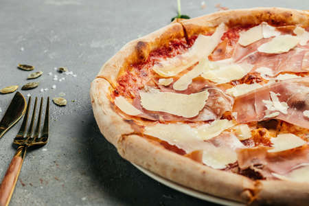 Delicious pizza with prosciutto crudo and parmesan cheese, Italian Food. top view.の写真素材
