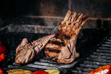 Grilled lamb ribs on grill. Hot rack of lamb with grilled vegetables, Culinary, cooking, bakery concept,の写真素材