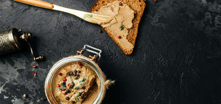 Chicken liver pate on bread and in jar. Long banner format. top view.