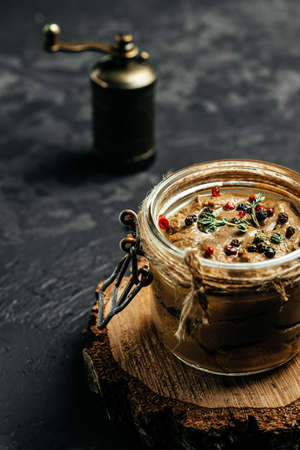 glass jar of liver pate on white table. Healthy dinner or lunch. vertical image. top view. place for text.の写真素材