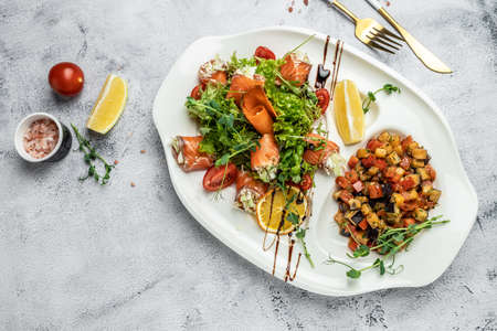 salad with vegetables, cheese and fresh salmon rolls. banner, menu, recipe place for text, top view.