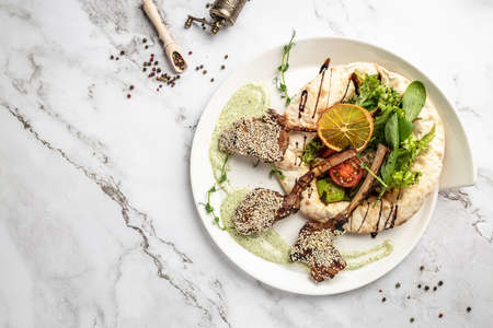 Lamb rack with pita bread and vegetables salad. Turkish shashlik. oriental cuisine. banner, menu,...