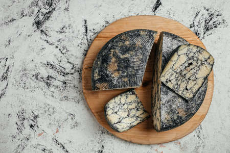 Asiago. Traditional italian hard cheese with cuttlefish ink. delicious dairy products. banner, menu,...