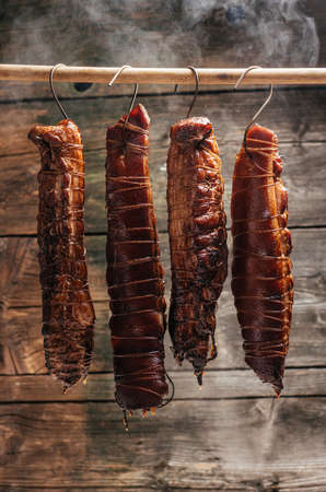 smoked pork. Traditional method of smoking meat in a smoke in a homemade smokehouse.の写真素材