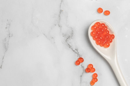 Red caviar in spoon and caviar on light background. Close-up salmon caviar. Delicatessen. gourmet food. seafood. appetizer, selective focus, place for text.の写真素材