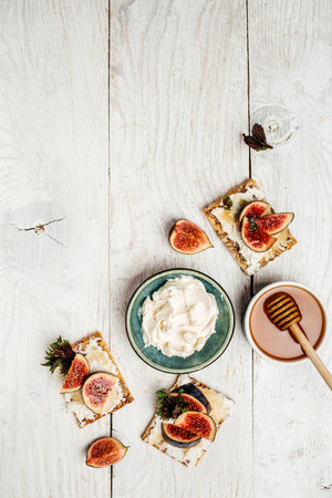 Bowl of cream cheese. Canape or crostini Fig, cream cheese and honey sandwiches. Food recipe background. close up.の写真素材