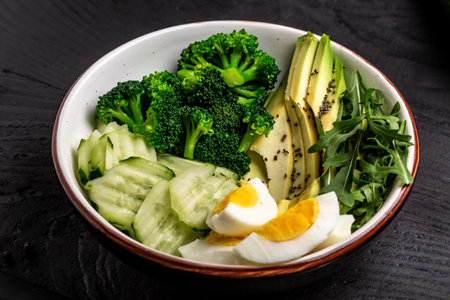 Ketogenic, paleo diet lunch bowl with avocado, cucumber, broccoli and egg. Healthy organic vegan salad. Delicious breakfast or snack, Clean eating, dieting, vegan food concept. top view.の写真素材