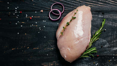Raw turkey fillet on cutting board, Cooking ingredients. natural healthy food concept. Long banner format. top view,の写真素材
