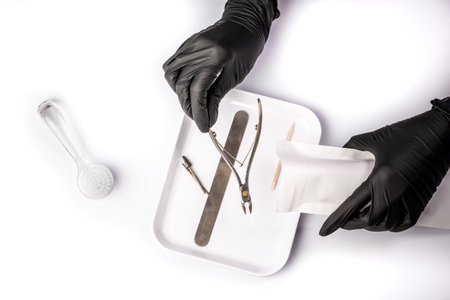 sterilized instruments on a white background. medicine or beauty salons. close up. Hands are taking manicure tools from craft envelope before manicure procedure. long banner format,の写真素材