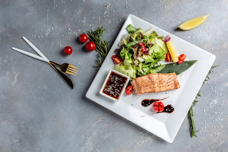 Grilled Salmon fish steak with fresh vegetables salad, Healthy salad for keto diet, friendly salmon with vegetables diet dish. paleo keto dietの写真素材