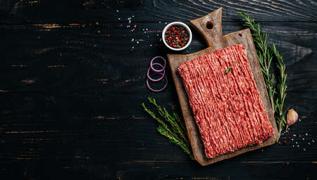 Fresh Raw Beef Minced Meat. Food recipe background. close up. Long banner format. top view.