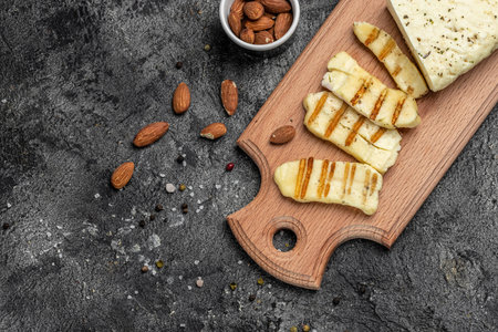 Grilled Halloumi cheese with mint and almonds on a wooden board, Cyprus squeaky cheese,の写真素材