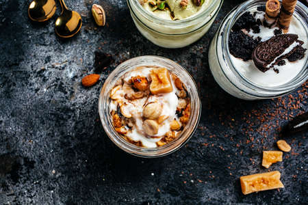 Caramel ice cream in glass jar. banner, menu, recipe place for text, top view.