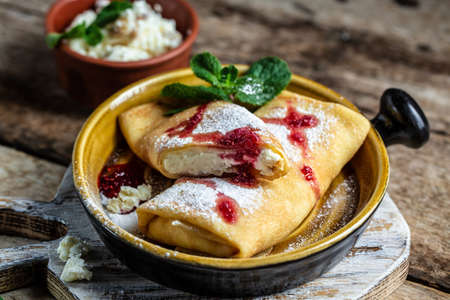 pancakes or crepes with cottage cheese flapjack thin cake ricotta sweet dessert vanilla cream. Thin pancakes, blini. Delicious breakfast or snack. Food recipe background. close up.の写真素材