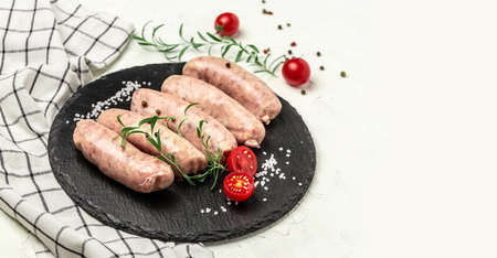 Raw sausages with herbs and spices. Ketogenic diet, vertical image. top view. place for text.の写真素材