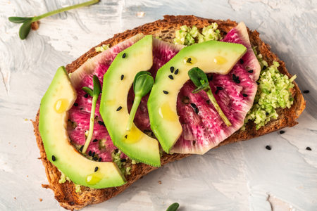 Avocado and watermelon radish toast with microgreen. Healthy green veggie breakfast sandwich. banner, catering menu recipe place for text, top view.の写真素材