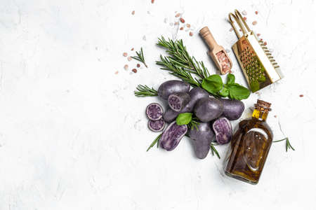 Raw cut purple sweet potatoes isolated on white background. Ipomoea batatas. Batata potatoes. Long banner format. top view.の写真素材