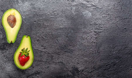 Stuffed avocado with strawberries. Detox and healthy superfoods concept. banner, menu recipe place...