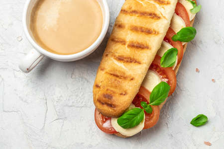 Delicious breakfast Caprese Panini Sandwich with tomato, mozzarella and basil, Clean eating,...
