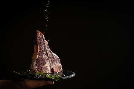 The T-bone or porterhouse steak of beef cut from the short loin. steak include T-shaped bone with meat on each side. Porterhouse steaks are cut from the rear end of the short loin.の写真素材