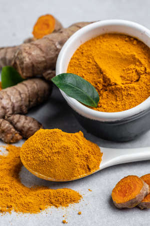 curcuma or curcumin root. Turmeric powder and fresh turmeric. on concrete background. Spice, natural...