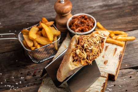 shaurma, Kebab, pita, gyros wrap sandwich stuffed with sausages from minced meat, french fries, fresh vegetables, sauce on rustic wooden background. fast food and junk food concept,の写真素材