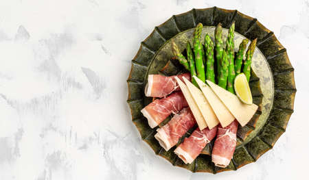 Antipasto platter. asparagus, jamon, ham, prosciutto, strawberries. ketogenic diet lunch concept. Keto Paleo diet menu top view.の写真素材