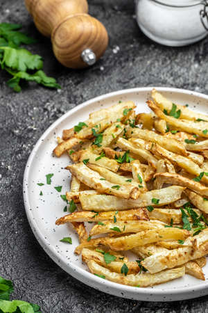 Oven roasted parsnips side dish on plate. Delicious vegetarian breakfast or snack, Clean eating,...