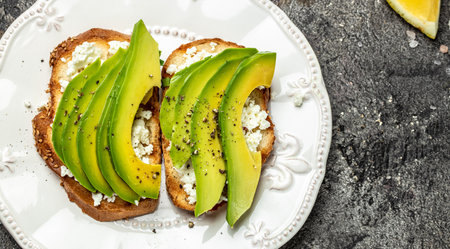Toasts with avocado rye bread, sliced avocado, pumpkin seeds for breakfast or lunch. Vegetarian sandwiches. Healthy, clean eating concept. Vegan or gluten free diet. top view.の写真素材