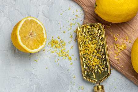 grating lemon zest Ready to Cook, Grater peel and lemon zest on light background, banner, menu, recipe, top view.の写真素材