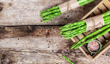 Asparagus. bunch of fresh asparagus. banches of fresh green asparagus on dark background, Pickled Green Asparagus. close up. long banner format,の写真素材