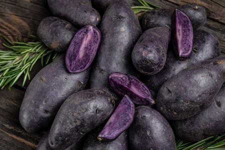 Japanese purple sweet potato. Raw sweet potatoes or batatas. pomoea batatas. Batata potato. vegan food ingredient. banner, menu, recipe place for text, top view.の写真素材