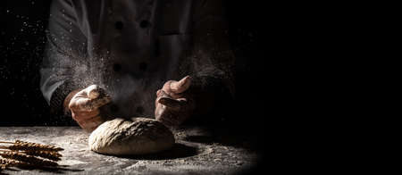 Beautiful and strong men's hands knead the dough from which they will then make bread, pasta or...