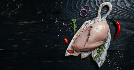 Raw turkey fillet on cutting board, Cooking ingredients. natural healthy food concept. Long banner format. top view,の写真素材