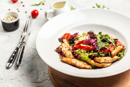 Healthy green salad with grilled chicken breast and sauce, Delicious balanced Healthy food, keto...