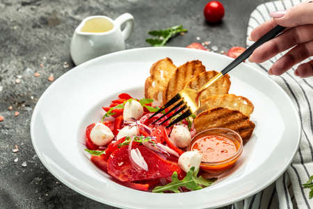 salad with fresh tomato mozzarella, onion and olive oil. Uzbek cuisine banner, menu, recipe place for text, top view.の写真素材