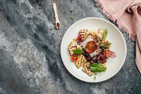 barbecue steak sliced with salad grilled vegetables, nuts, sauce and parmesan. Italian food concept. banner, menu, recipe place for text, top view.の写真素材