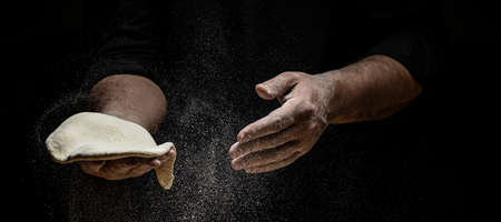 Clap hands of baker with flour. Beautiful and strong men's hands knead the dough make bread, pasta...