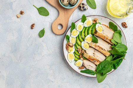 Ketogenic diet food, chicken fillet, quail eggs, avocado, spinach, walnut. healthy meal concept on a light background, banner, menu, recipe place for text, top view,の写真素材