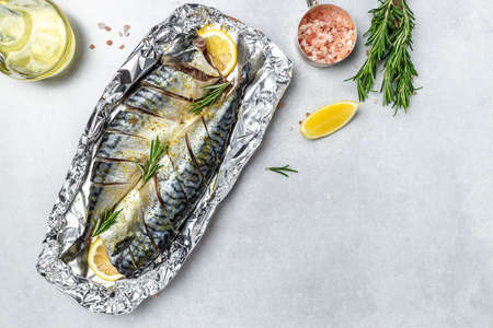 marinated mackerel with spices and herbs ready for baking on a light background, Culinary, cooking concept. place for text, top view,の写真素材