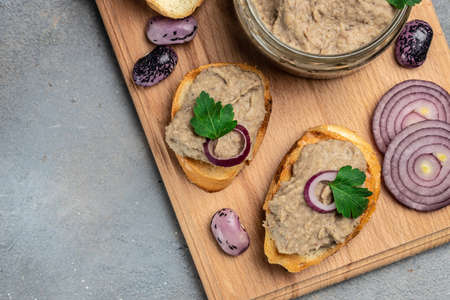 Toasts bread with beans paste, Mexican cuisine pate of beans in glass jar. healthy vegetarian food...