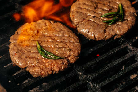 Beef steaks pieces of meat on the grill with flames. american cuisine. The concept cooking meat. Food recipe background. close up. place for text.の写真素材