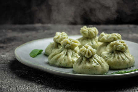 Hot steam Khinkali with cheese and spinach dumplings. cooking khinkali. National Georgian cuisine. banner, menu, recipe place for text,の写真素材