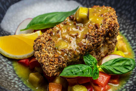Close up fish fillet breaded in nuts with pepper sauce and vegetables, Healthy fats, clean eating for weight loss, Ketogenic diet food. recipe topview,の写真素材