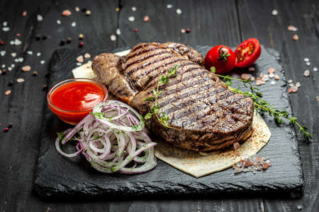 Medium rare Ribeye steak or beef steak. Dry Aged Barbecue Ribeye Steak beef steak sliced with large fillet piece. banner, menu, recipe place for text, top view.の写真素材
