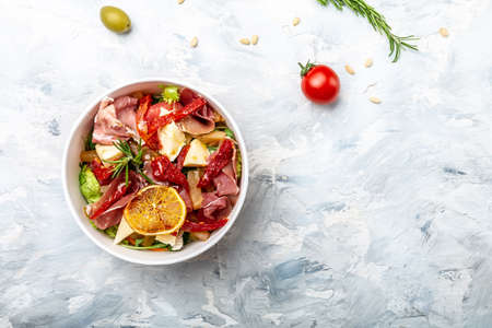 Healthy salad with Prosciutto, ham and grapefruit jamon, salad mix, grapefruit, cherry tomatoes, parmesan cheese. in plastic package for take away or food delivery. place for text, top view.の写真素材