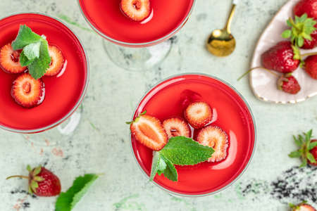 Italian panna cotta dessert with strawberry and mint on a light background. Summer yogurt dessert. space for text.の写真素材